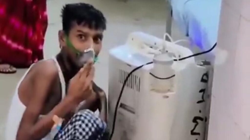 Uproar over patient in oxygen mask sitting on the floor in U.P. Azamgarh hospital